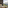Outdoor balcony with chaise lounge, book, and expansive mountain scenery.