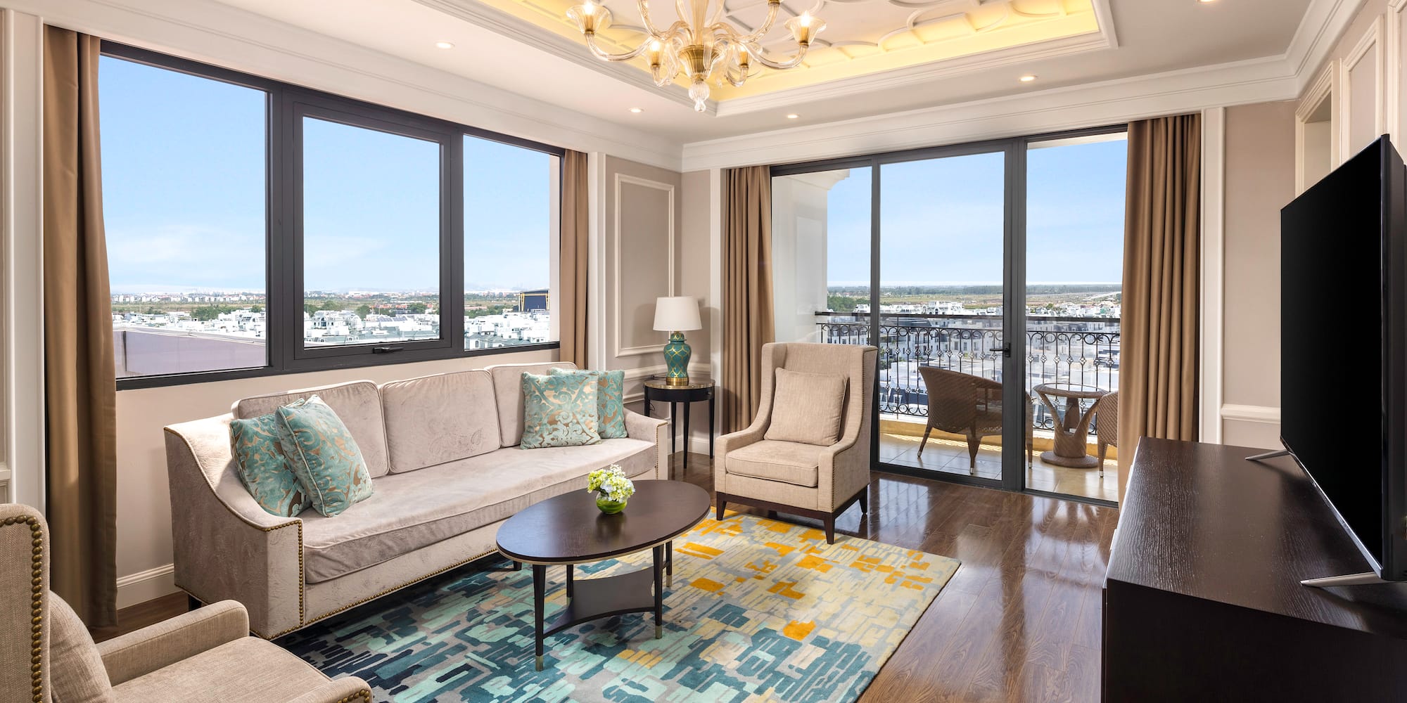 a living room with a chandelier and couches