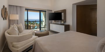 a bedroom with a television and a bed