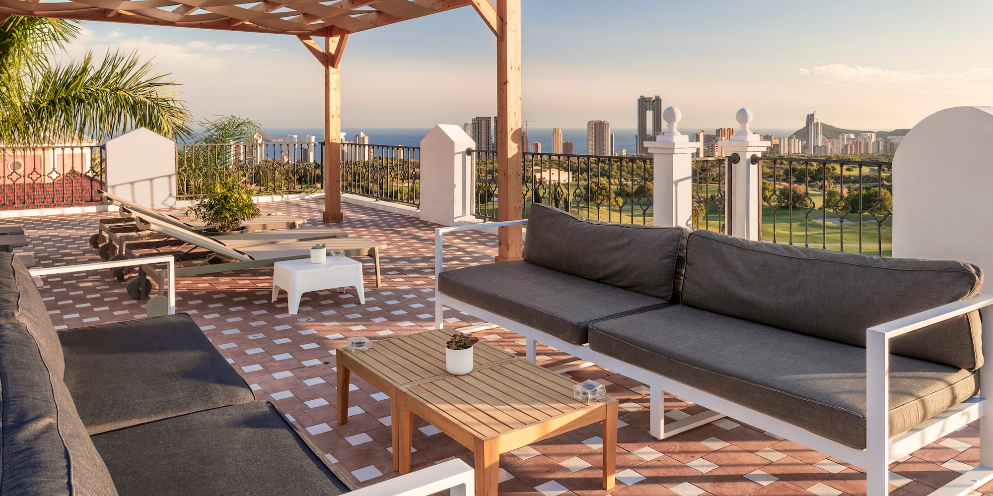 a patio with a view of a city and a golf course