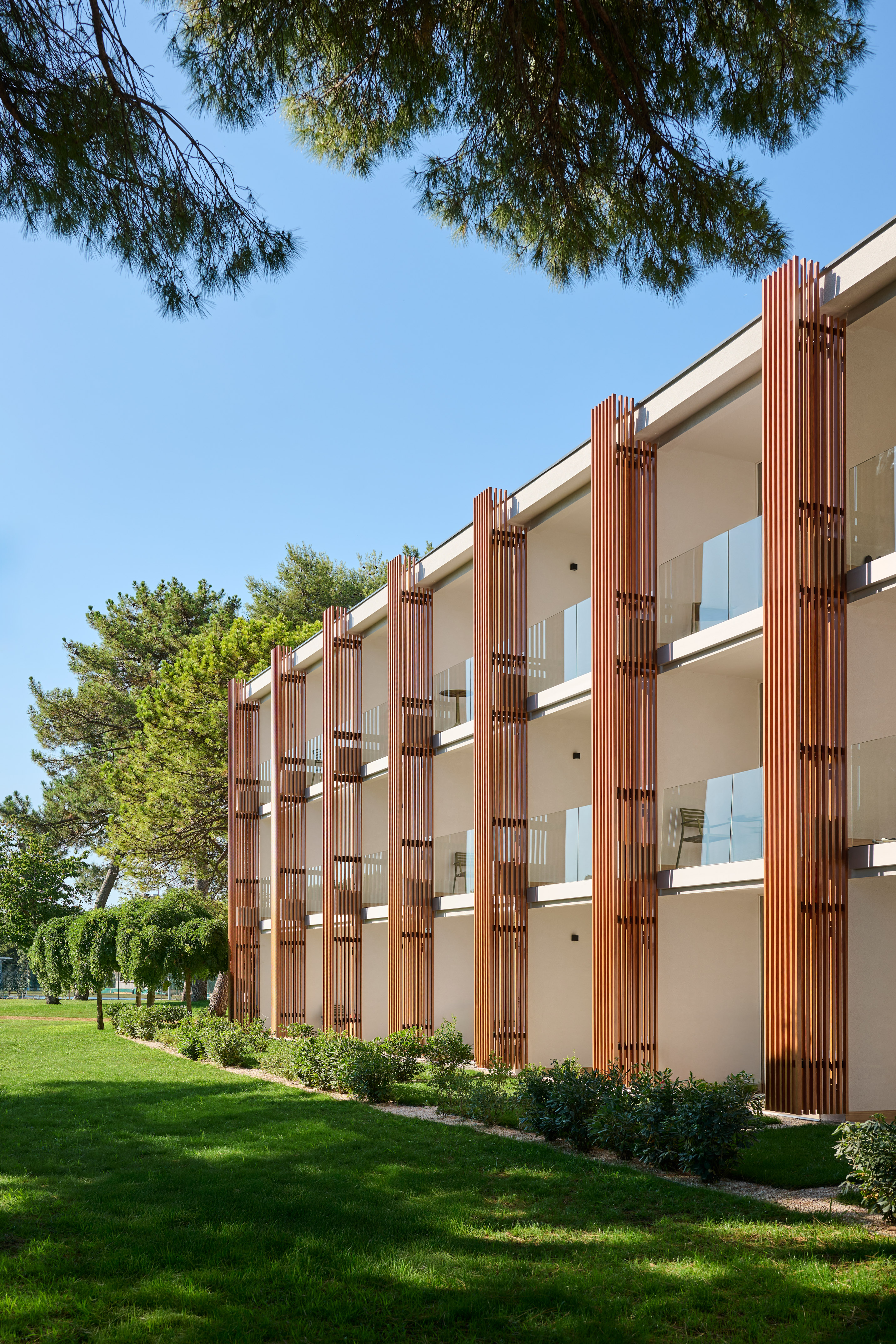 a building with trees and grass