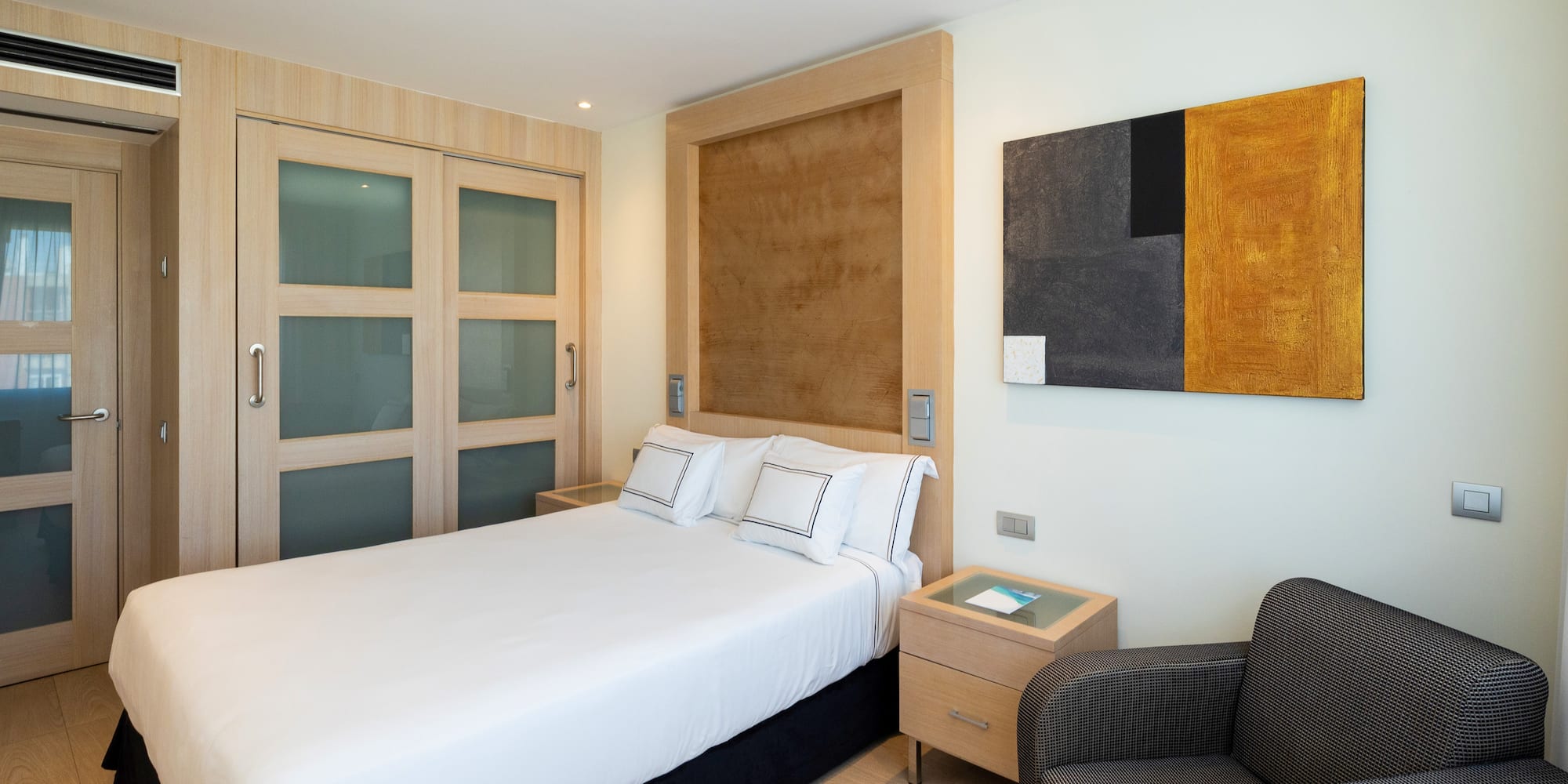 a bedroom with a bed and a chair