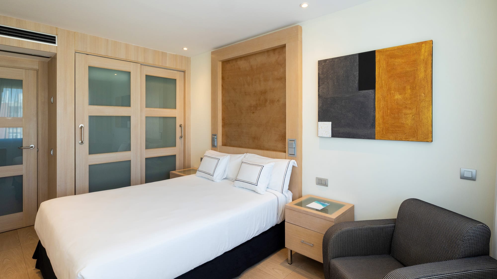 a bedroom with a bed and a chair