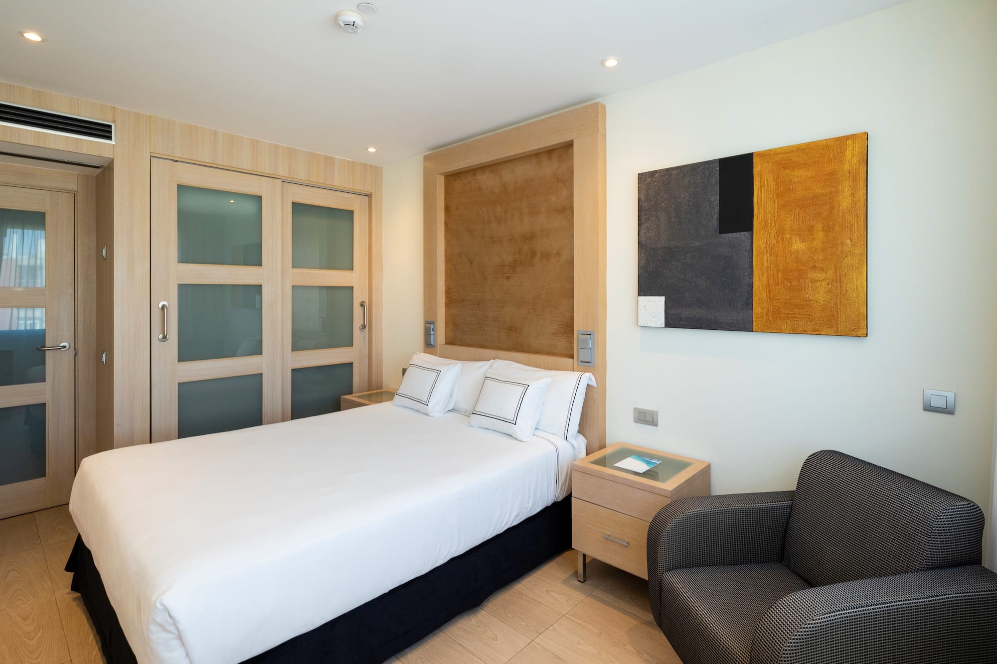 a bedroom with a bed and a chair