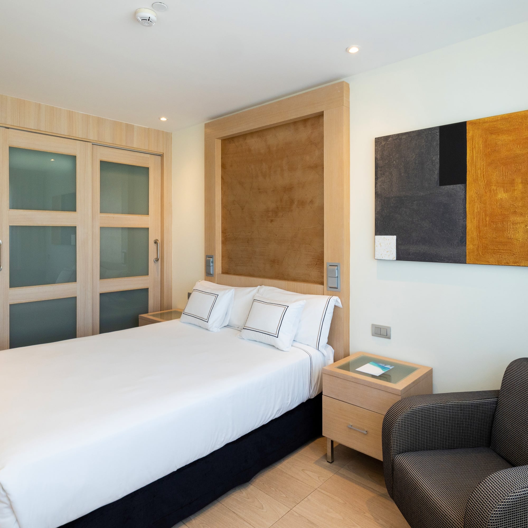 a bedroom with a bed and a chair