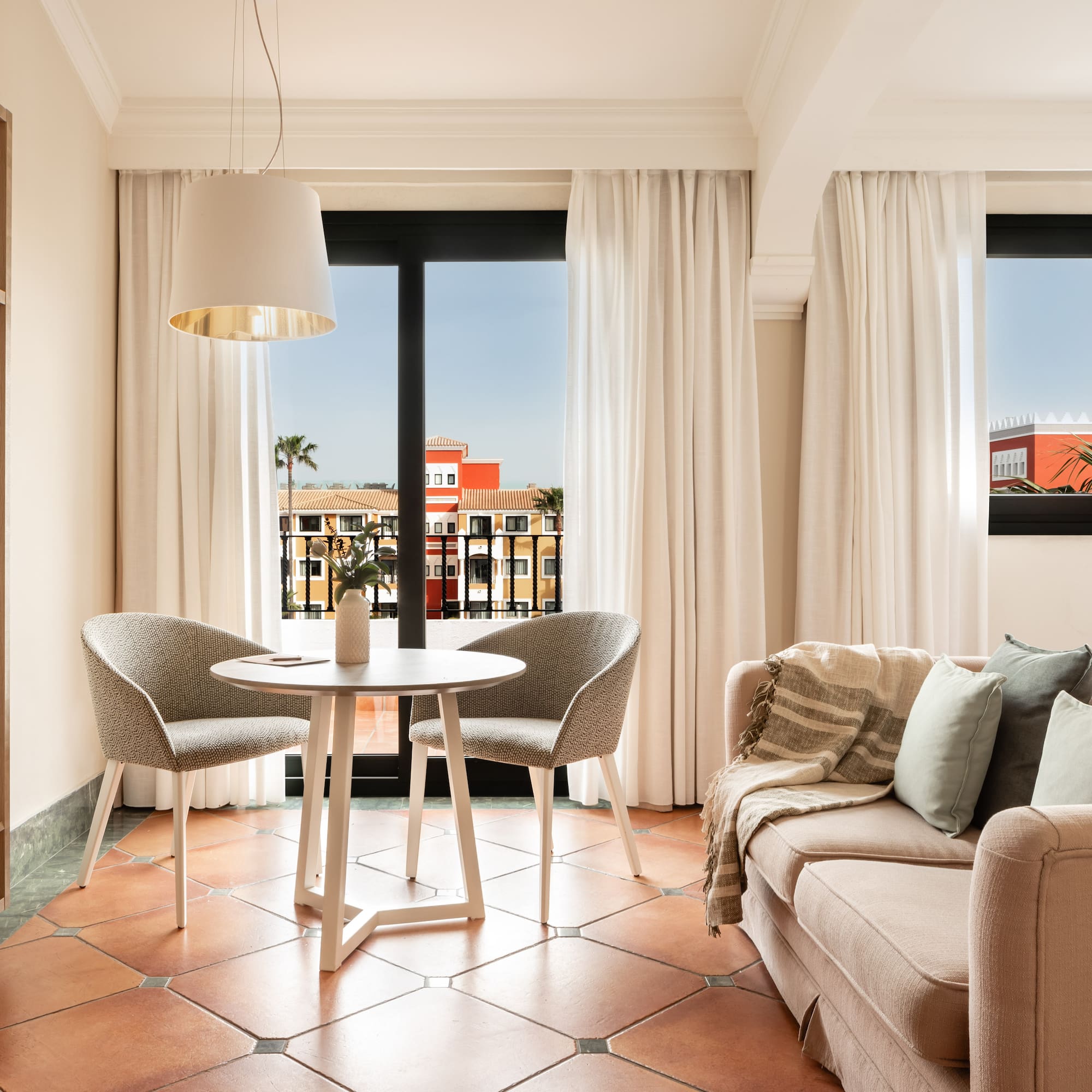 a living room with a couch and chairs