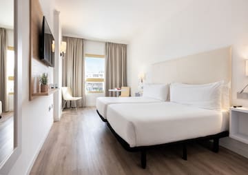 a room with two beds and a tv