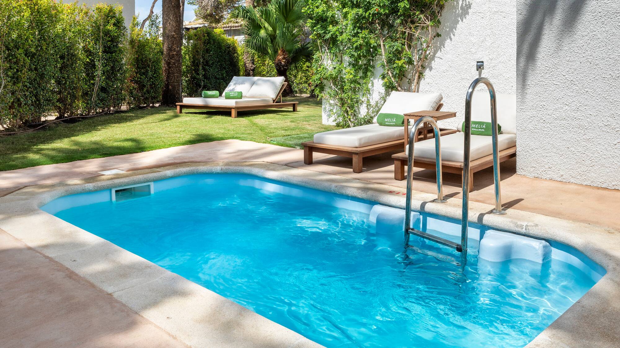 a pool with lounge chairs and a deck