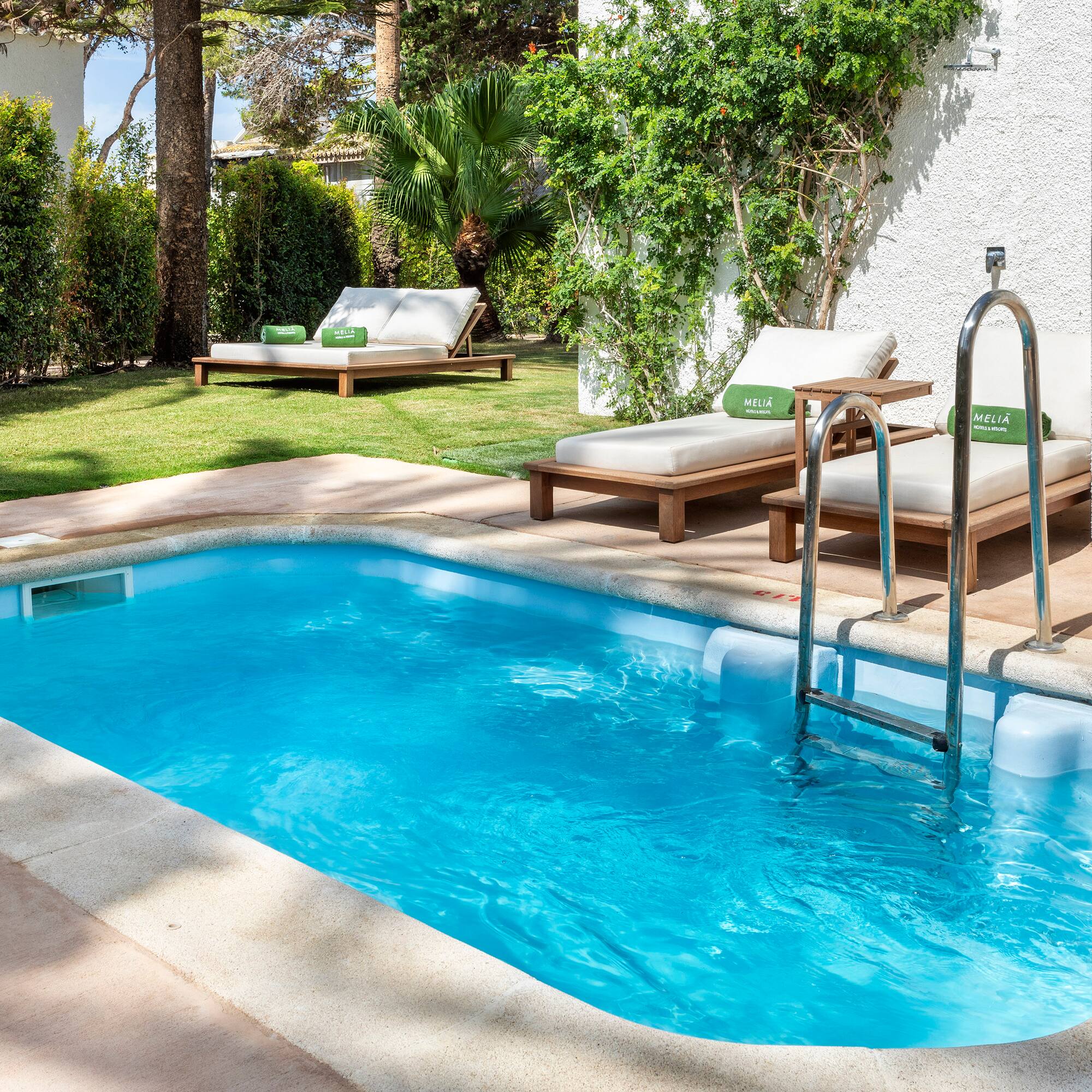 a pool with lounge chairs and a deck