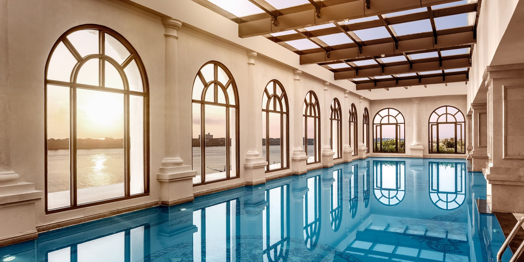 a large indoor pool with arched windows