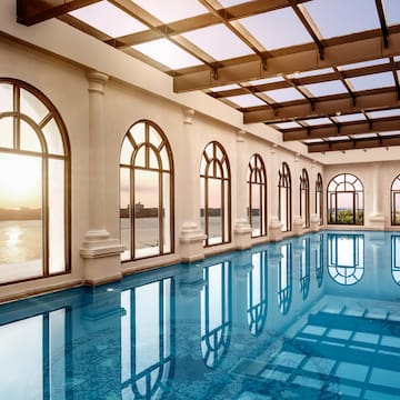 a large indoor pool with arched windows