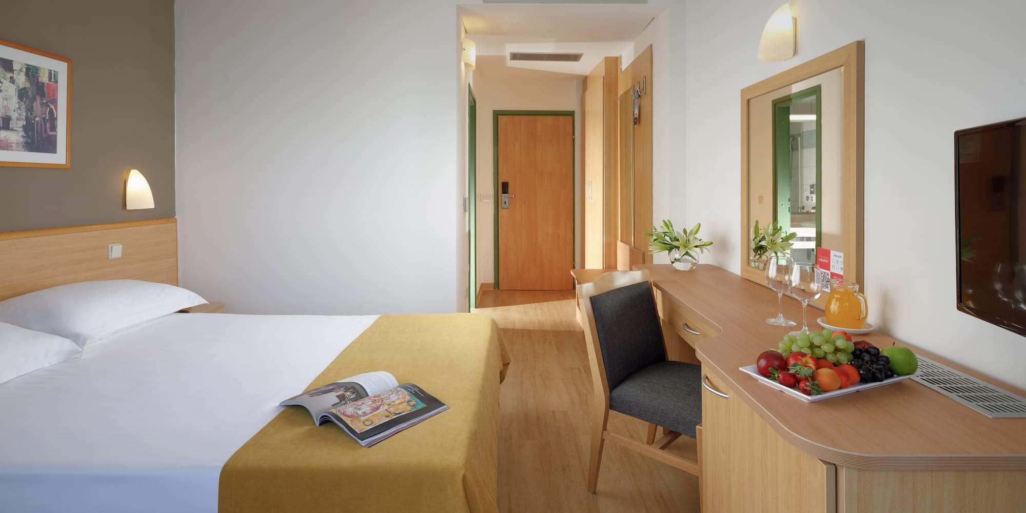 a room with a bed and a table and chair