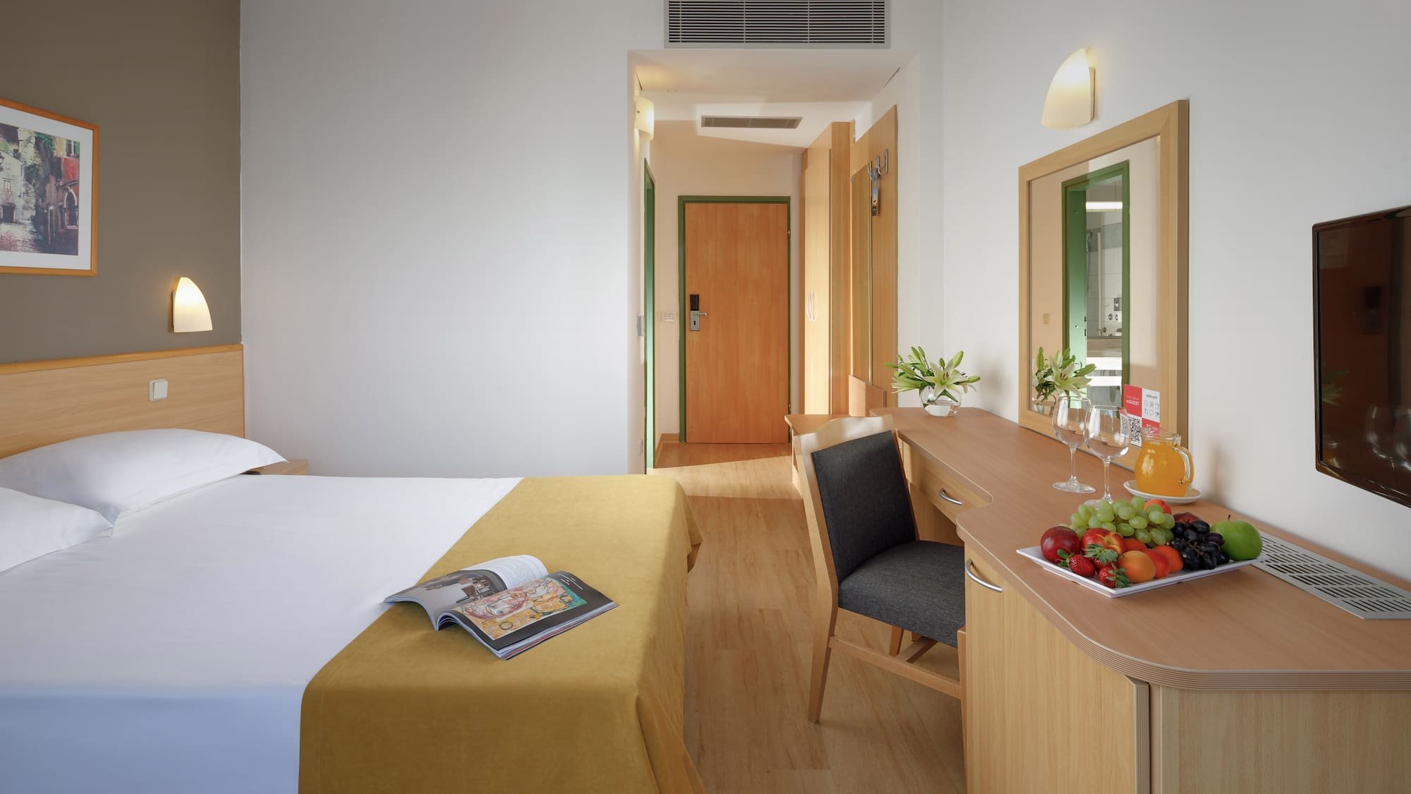 a room with a bed and a table and chair