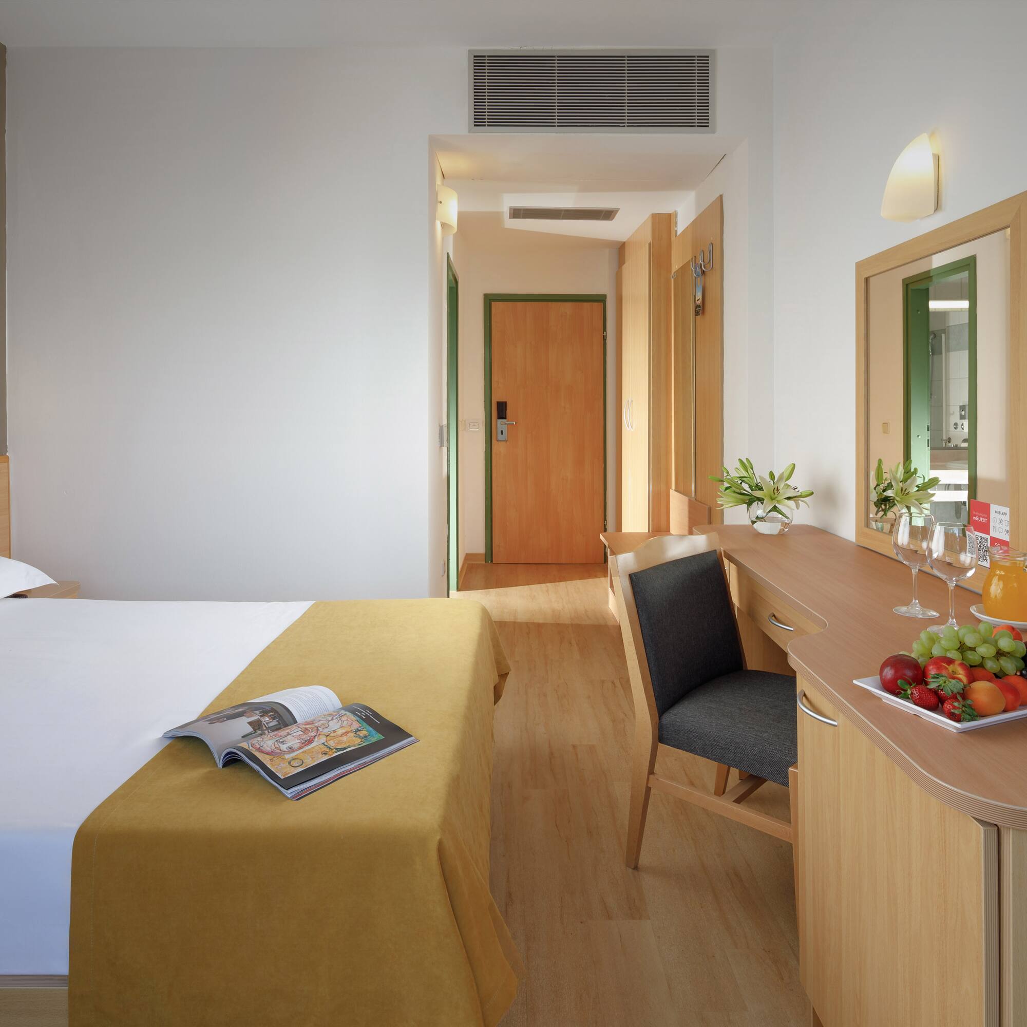 a room with a bed and a table and chair