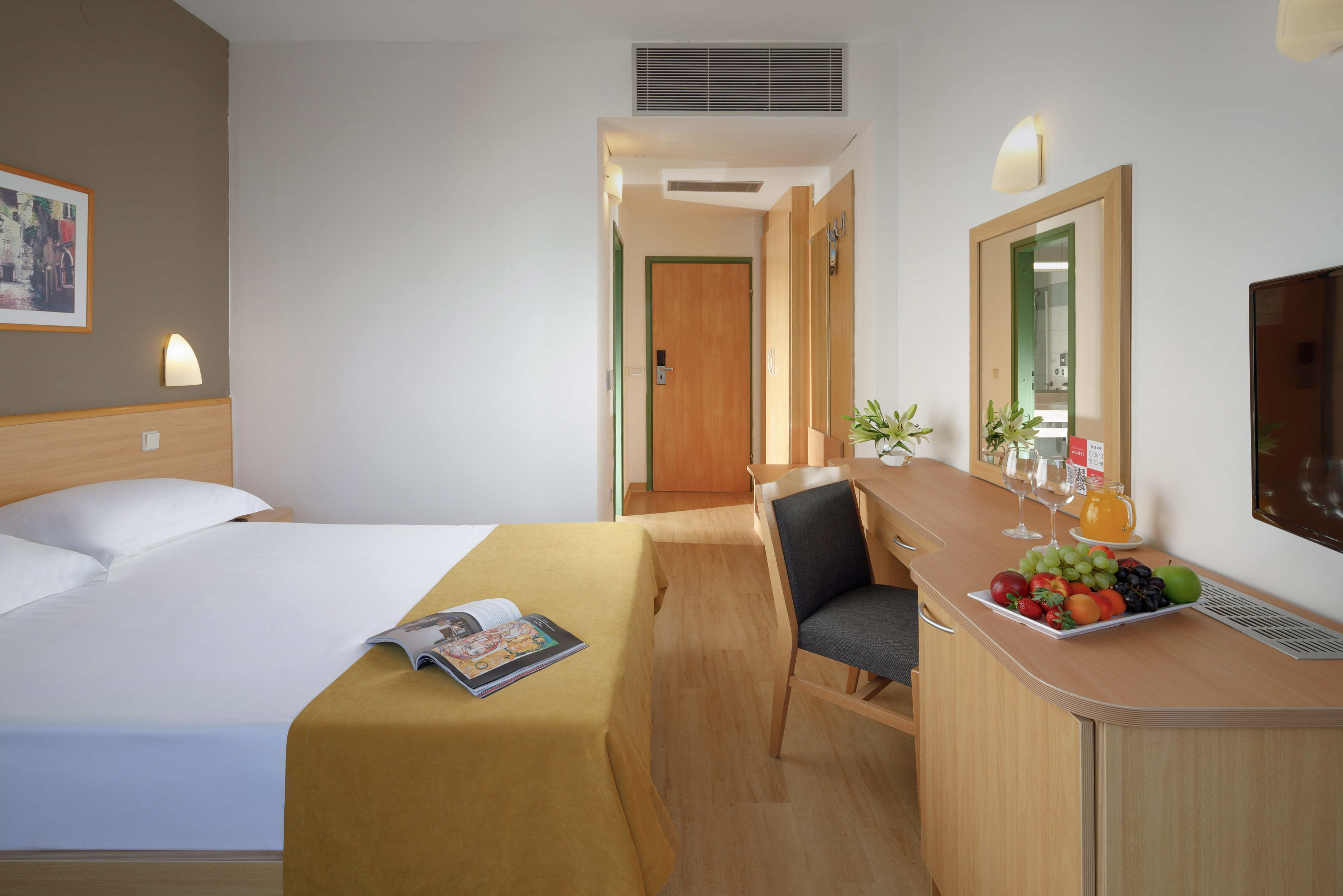a room with a bed and a table and chair