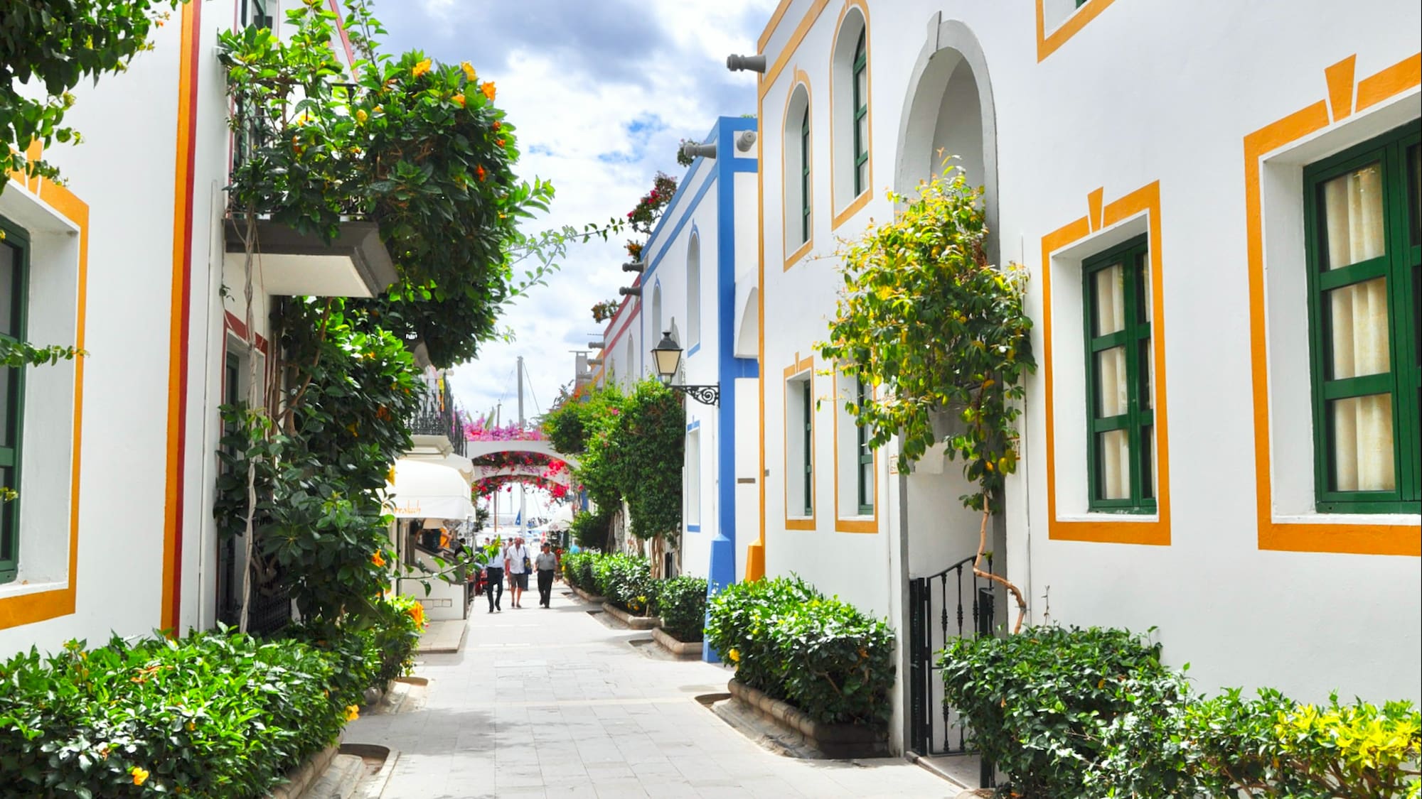 a white buildings with green and yellow trim