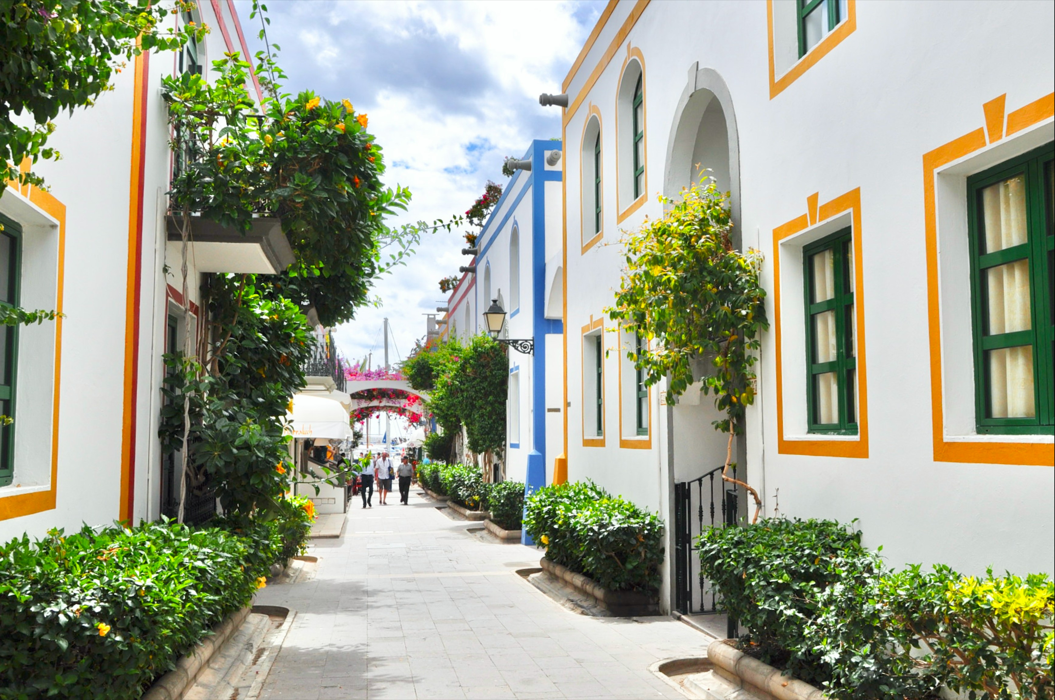 a white buildings with green and yellow trim
