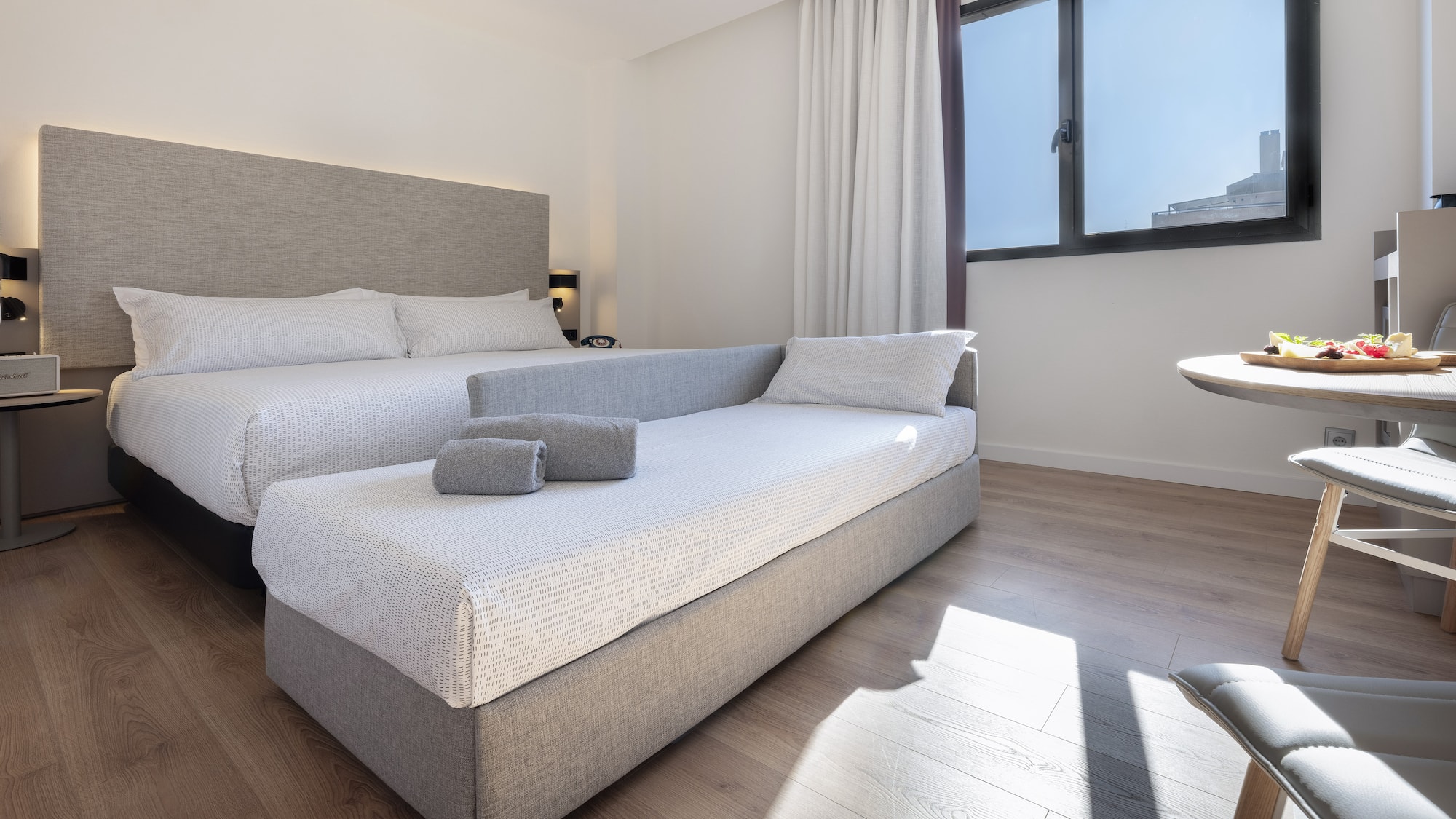 a room with two beds and a table