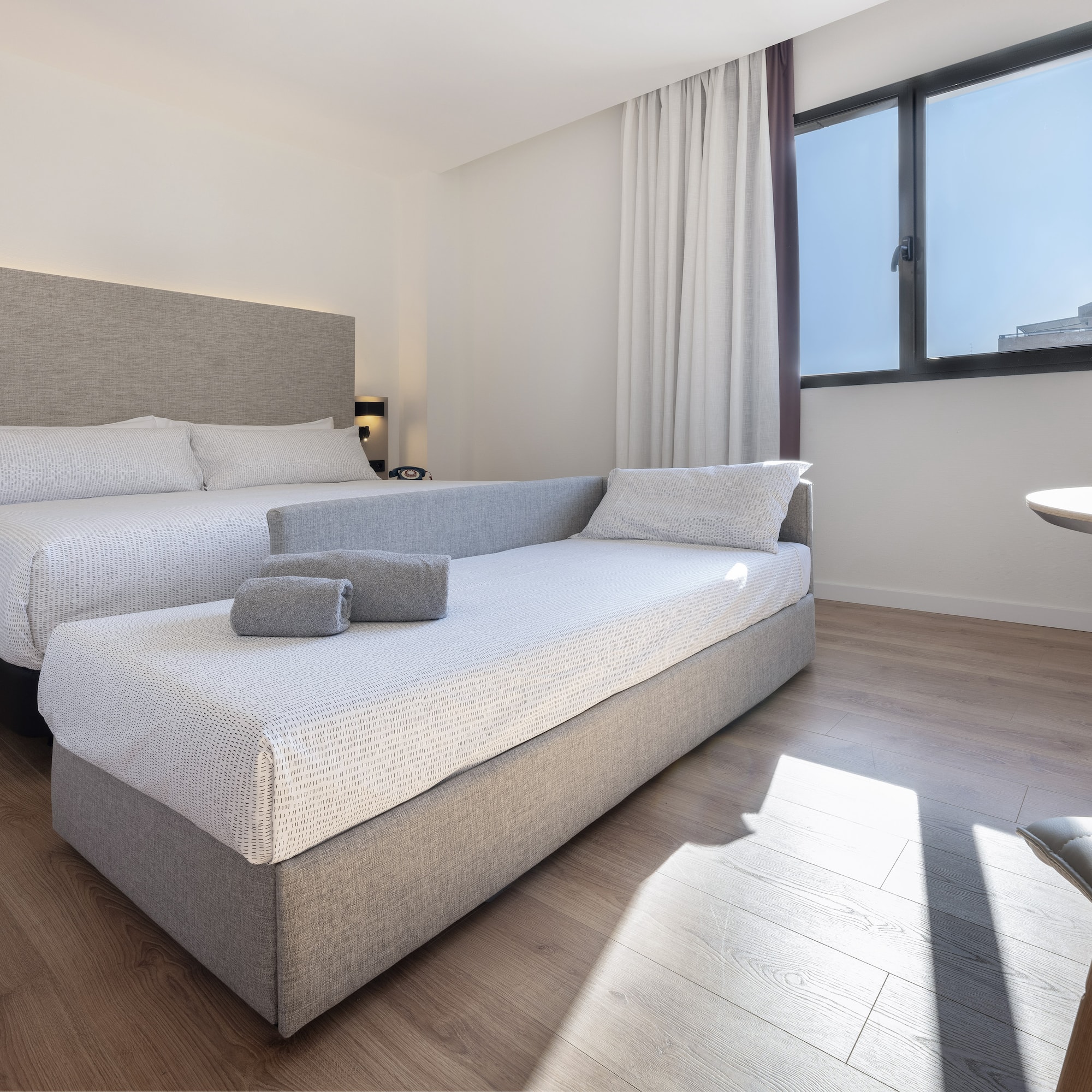 a room with two beds and a table