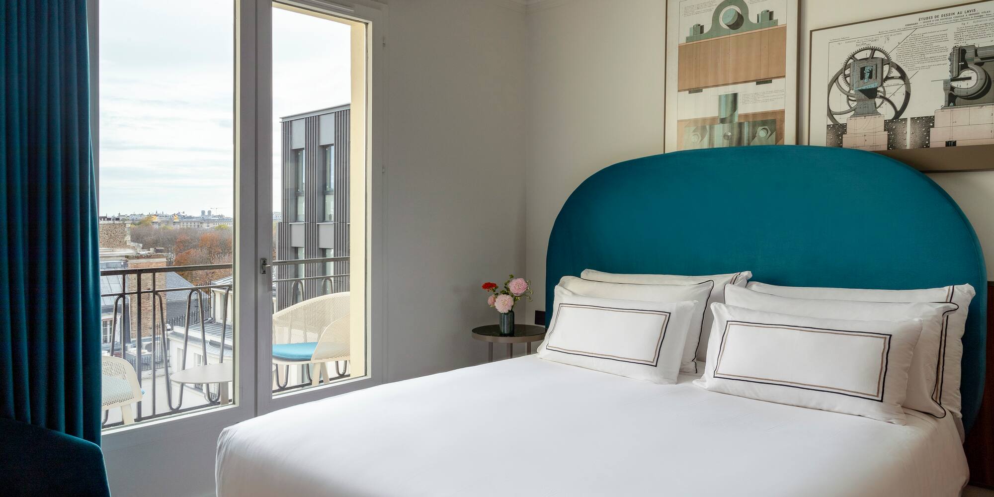 a bed with a blue headboard and white sheets