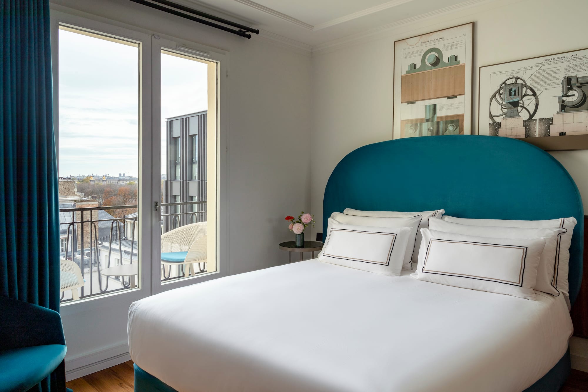 a bed with a blue headboard and white sheets