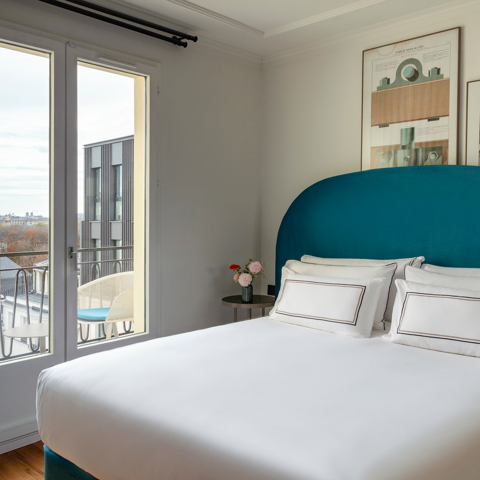 a bed with a blue headboard and white sheets