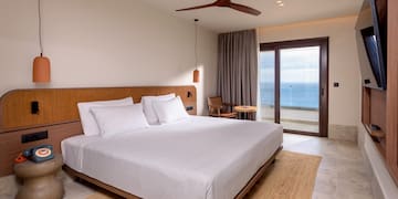 a bed with a fan and a window