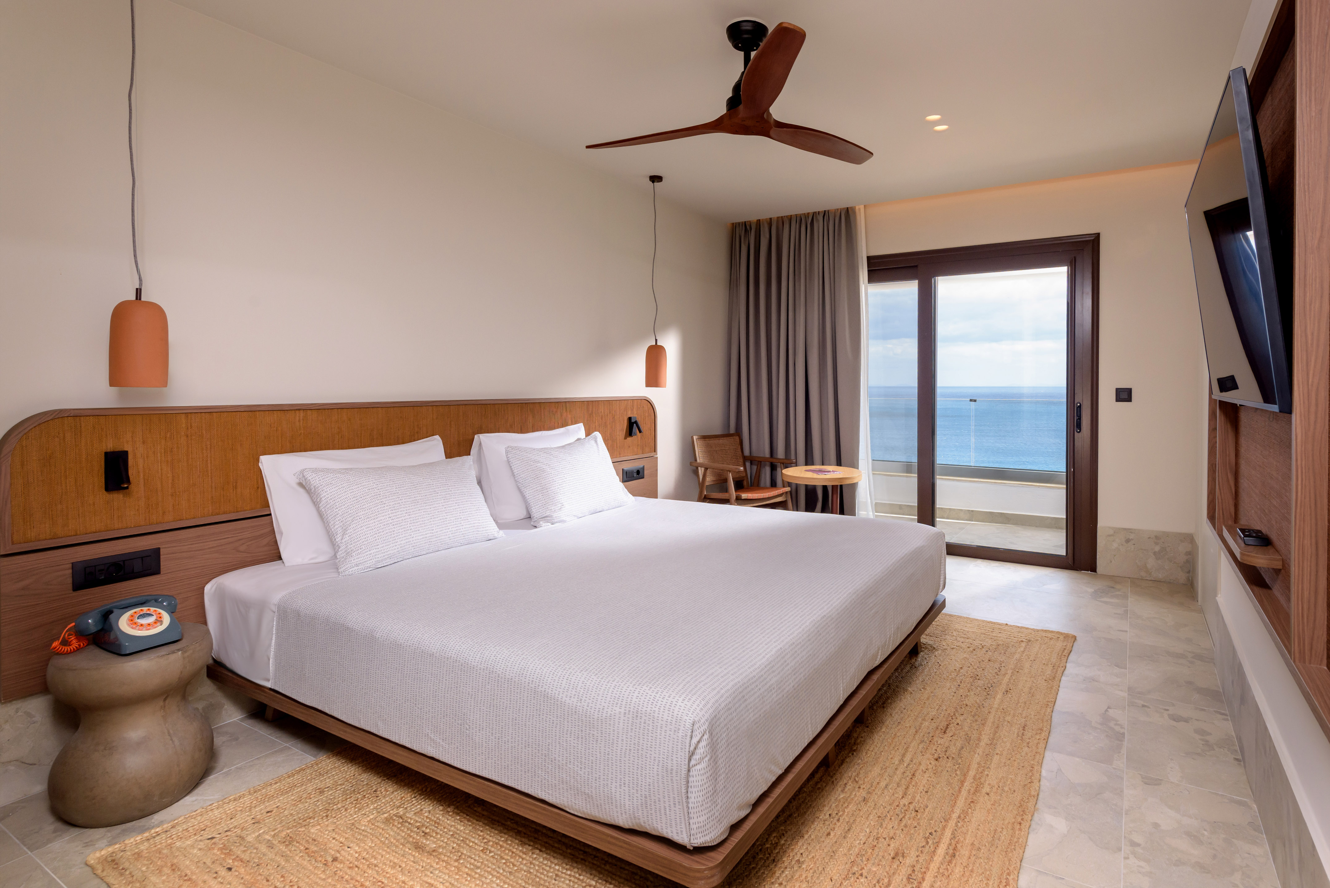 a bed with a fan and a window