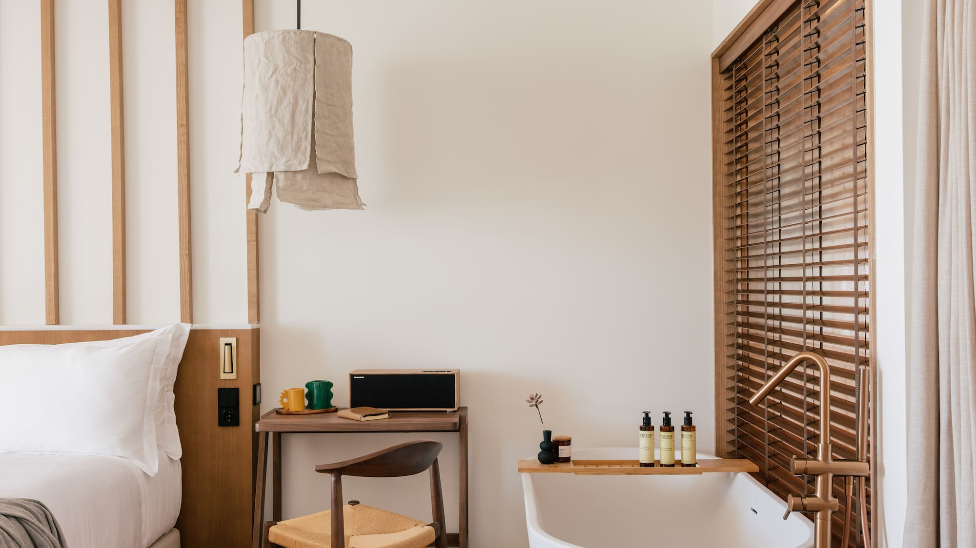 a room with a bathtub and a desk