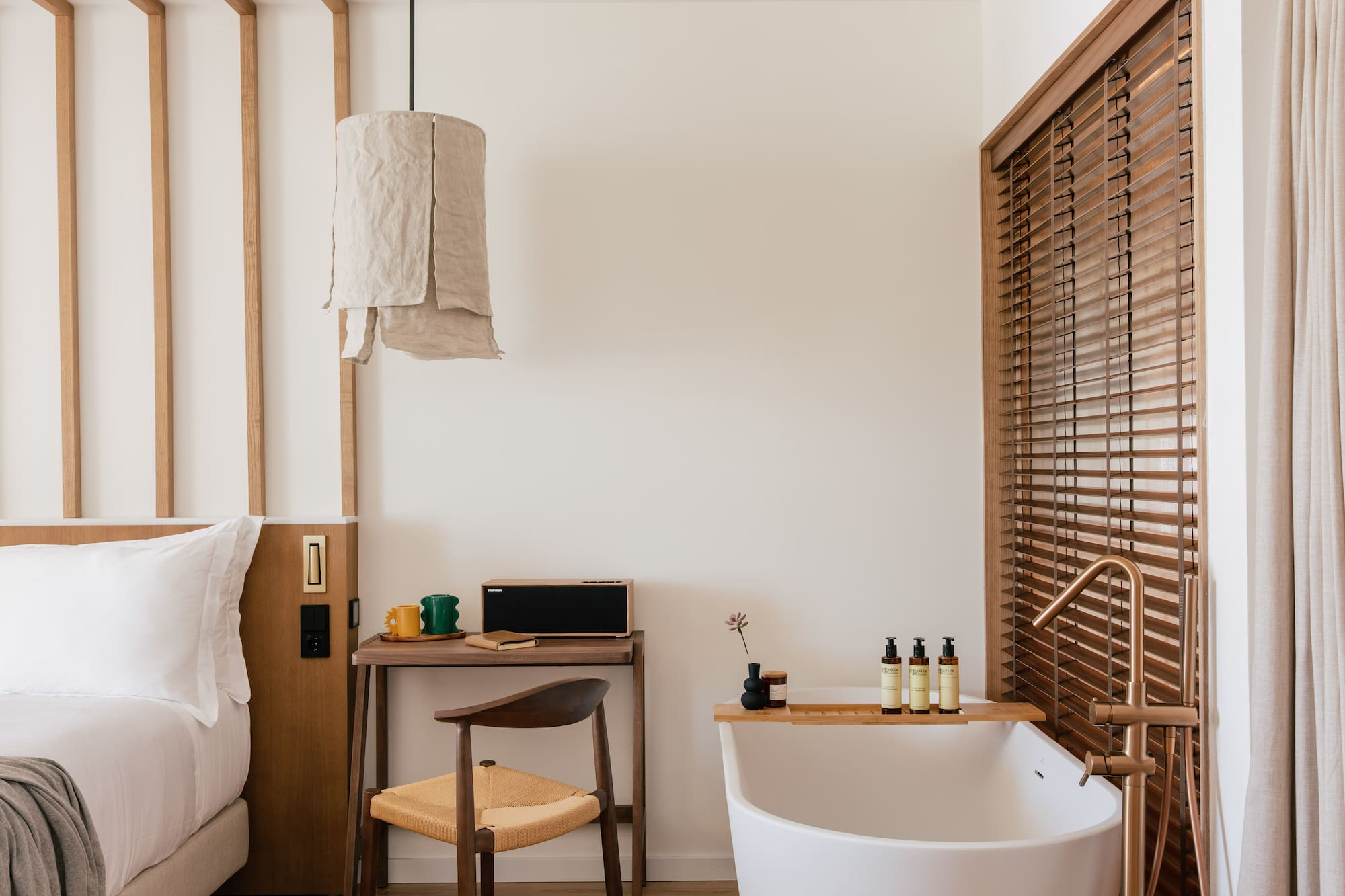 a room with a bathtub and a desk