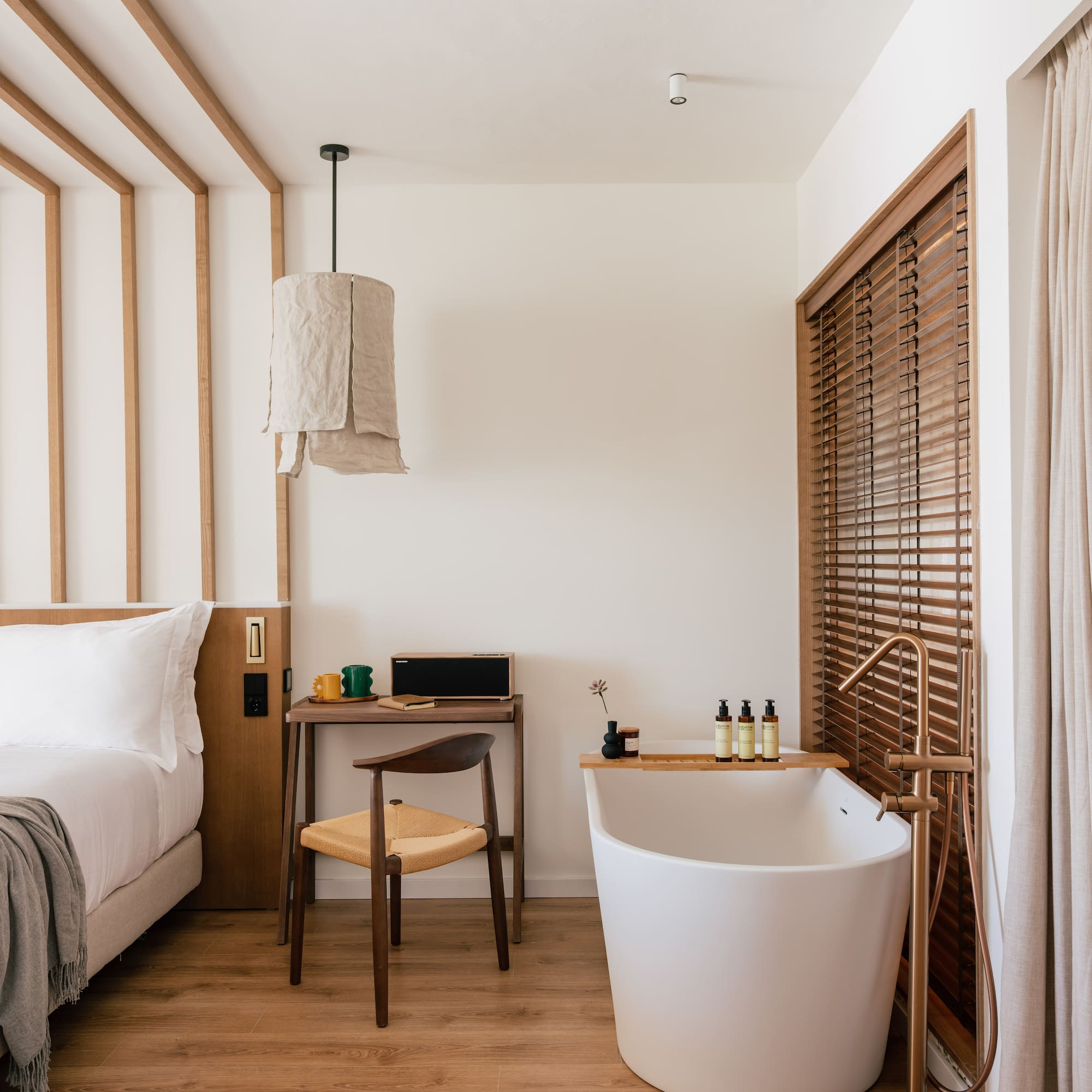 a room with a bathtub and a desk