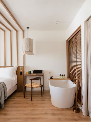 a room with a bathtub and a desk