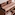 BetterMe yoga mats, blocks, and hand weights on a wooden shelf.