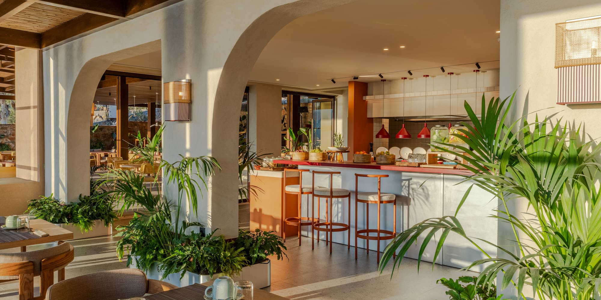 a room with a table and chairs and tables with plants