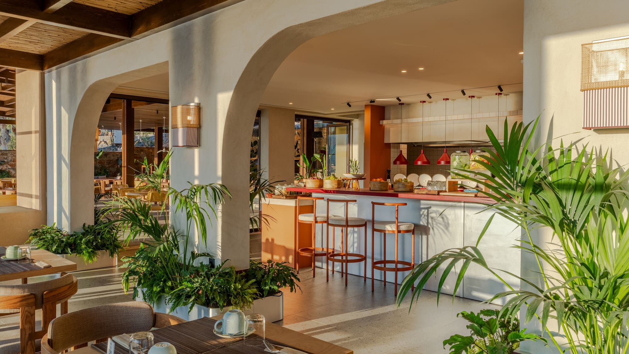 a room with a table and chairs and tables with plants