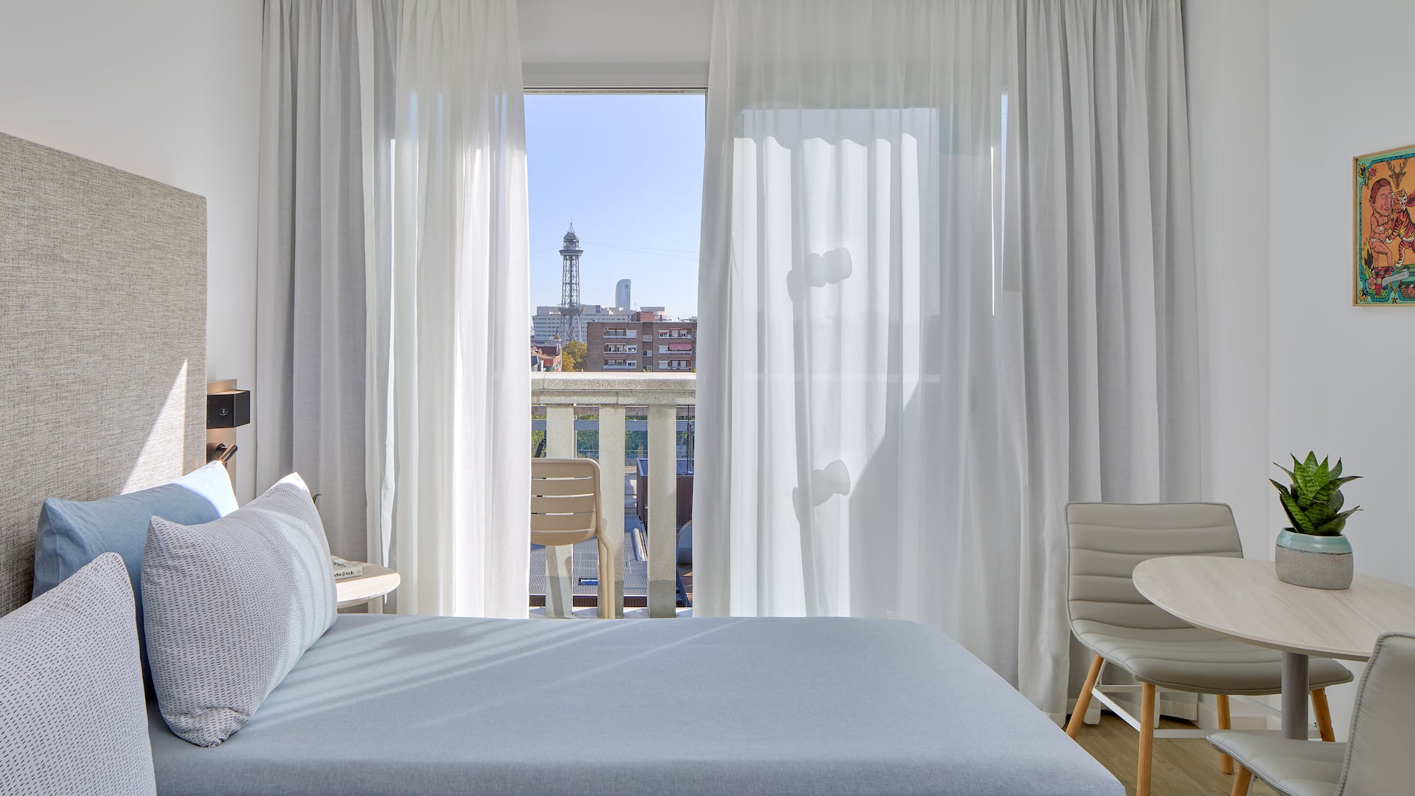 a bedroom with a table and chairs and a table and chairs