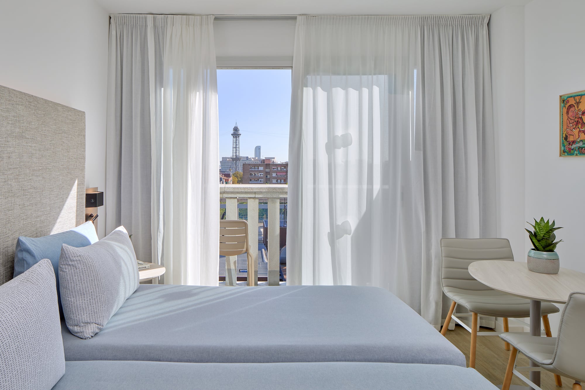 a bedroom with a table and chairs and a table and chairs