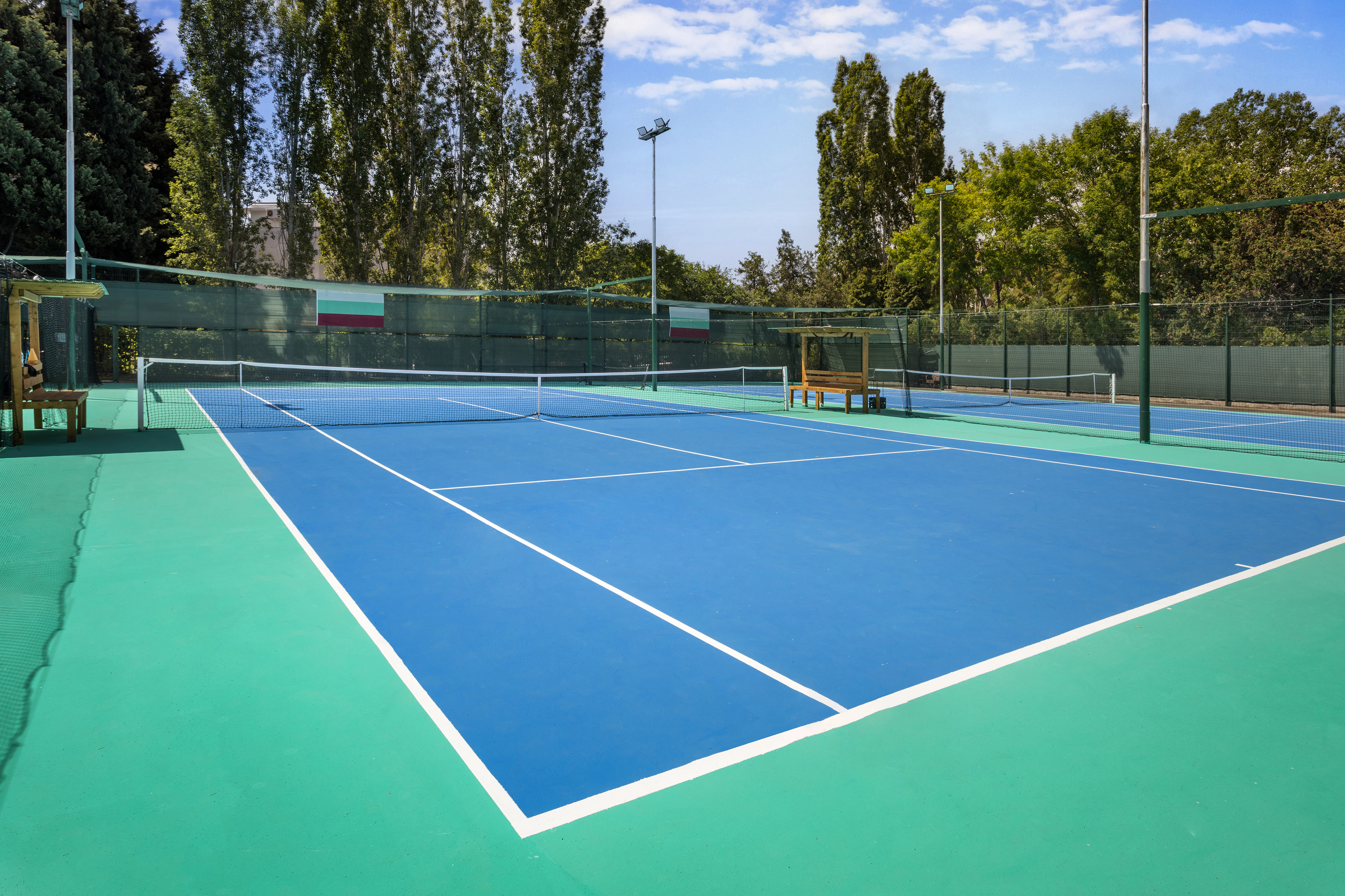 a tennis court with a bench and net