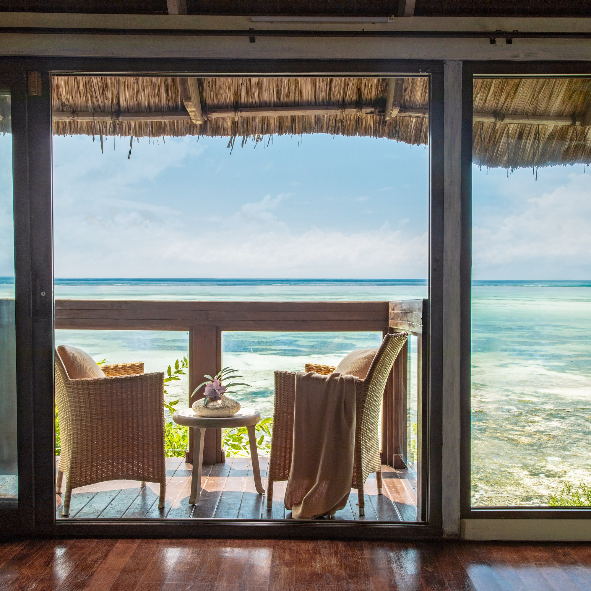 a view of the ocean from a patio door