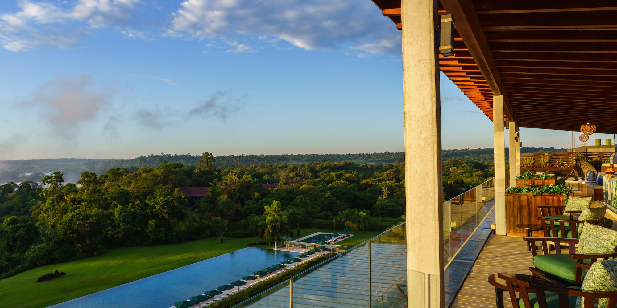 a deck with a pool and trees in the background