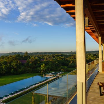 a deck with a pool and trees in the background
