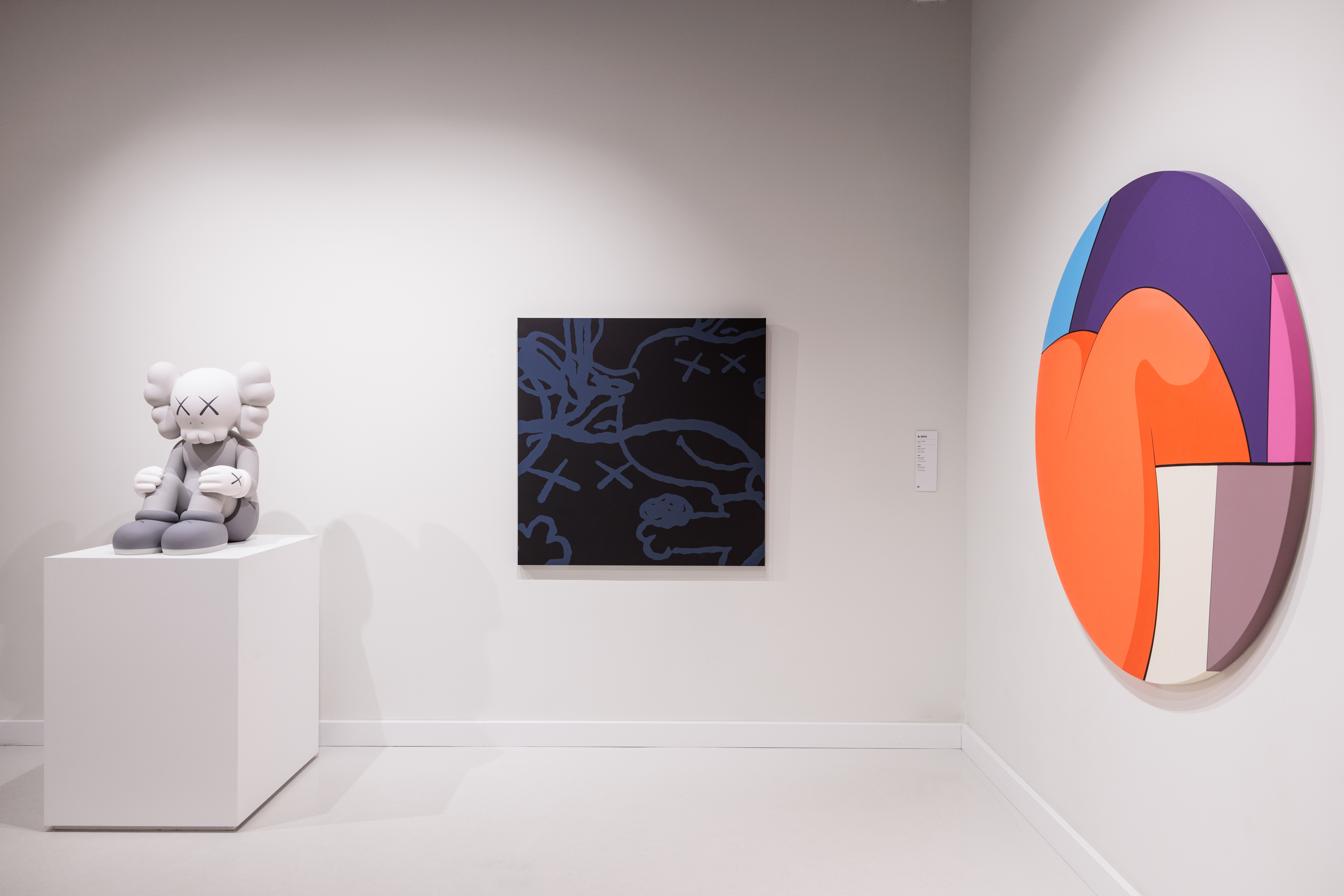 a white room with a large painting and a white bear