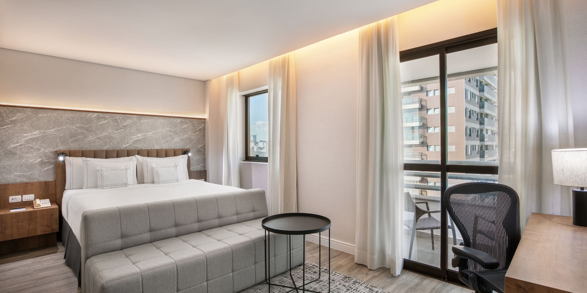 a bedroom with a bed and a chair