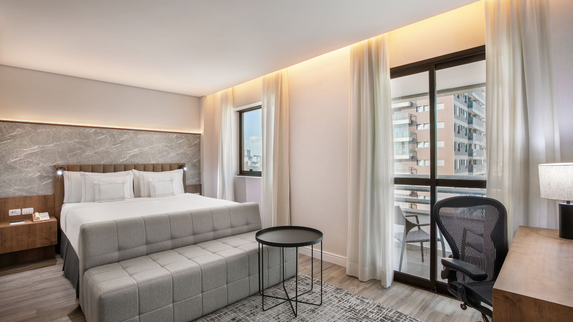 a bedroom with a bed and a chair