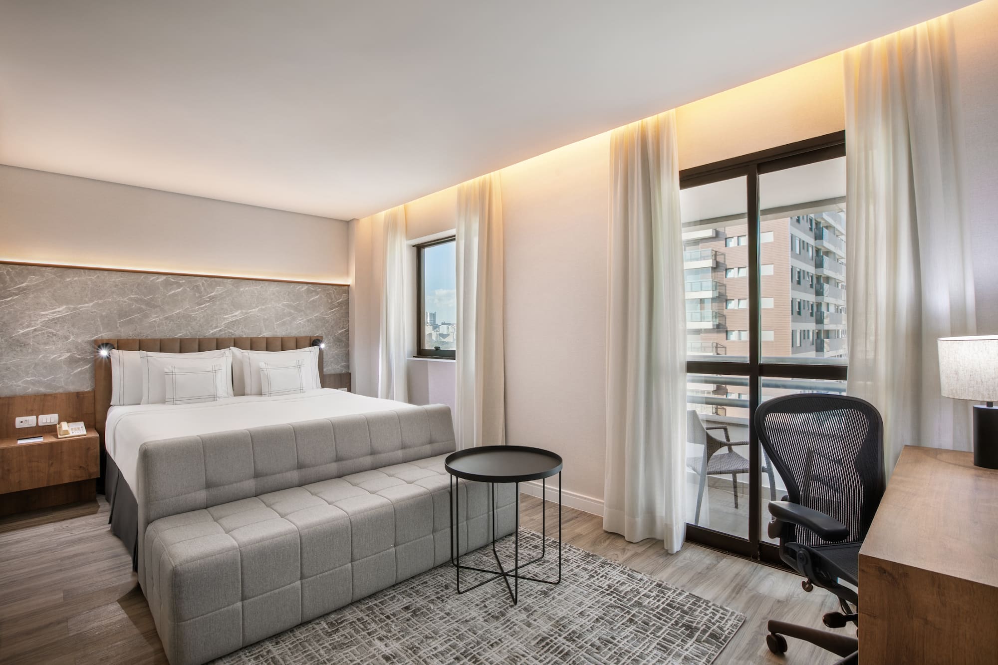 a bedroom with a bed and a chair