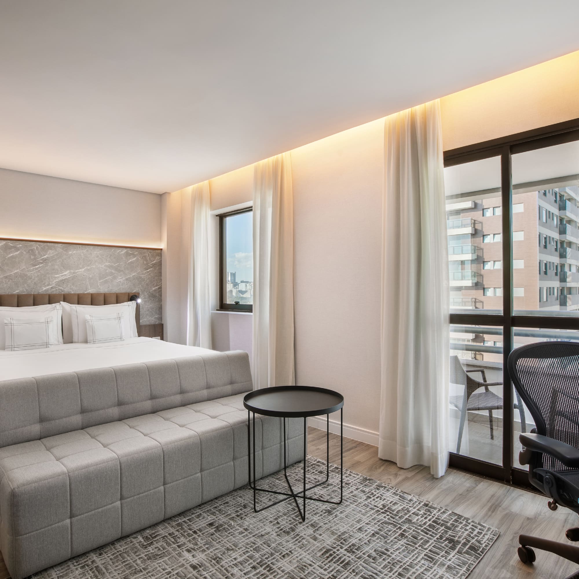 a bedroom with a bed and a chair