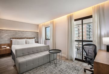 a bedroom with a bed and a chair