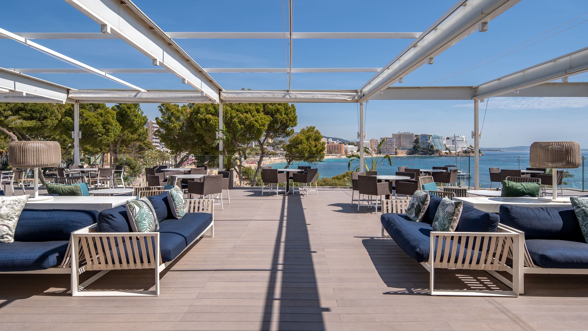 a patio with a view of the water and a city