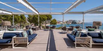 a patio with a view of the water and a city