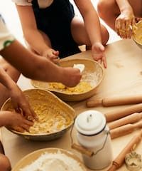 a group of people making dough
